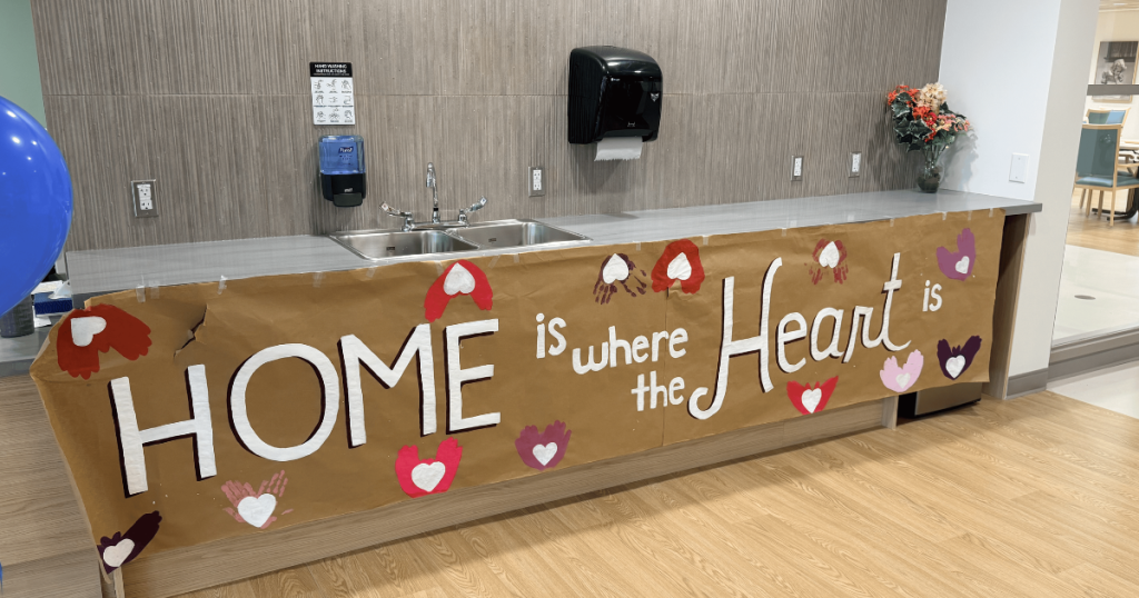 Banner made by the team that says "Home is where the Heart is"