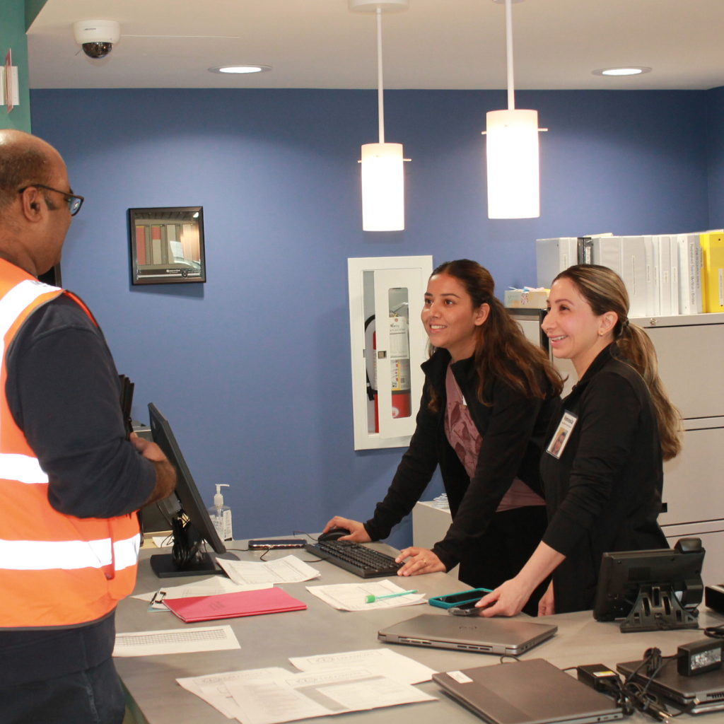 Lead technology expert conversing with two nurses at the Communications hub.